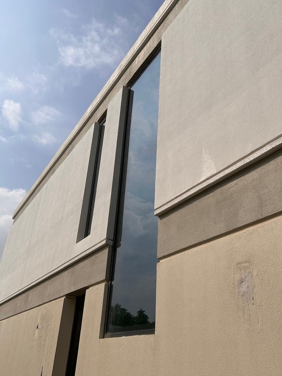 Tall glazed window installed in a building facade